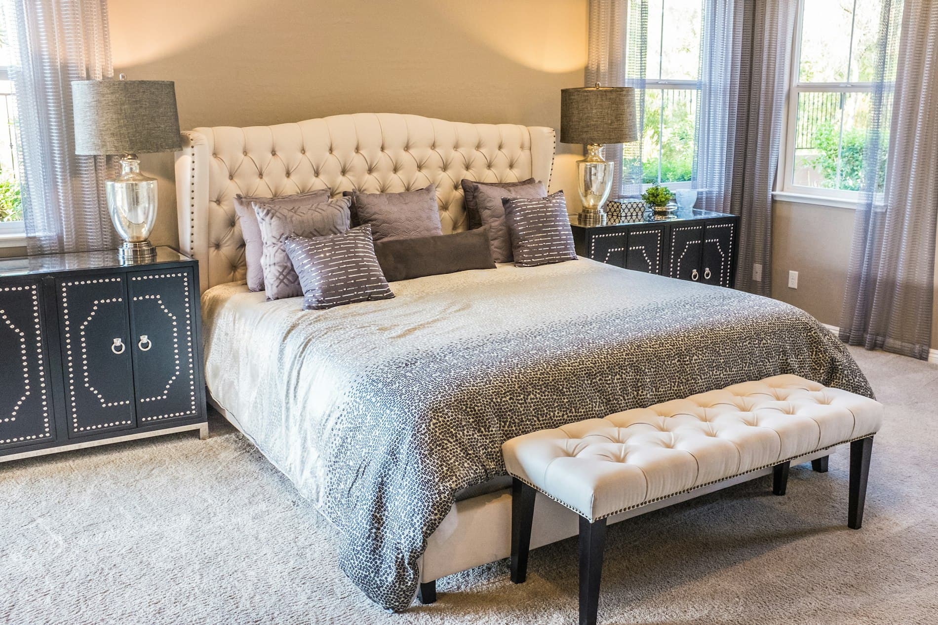 Cosy cream tufted bed in a warm, naturally lit bedroom