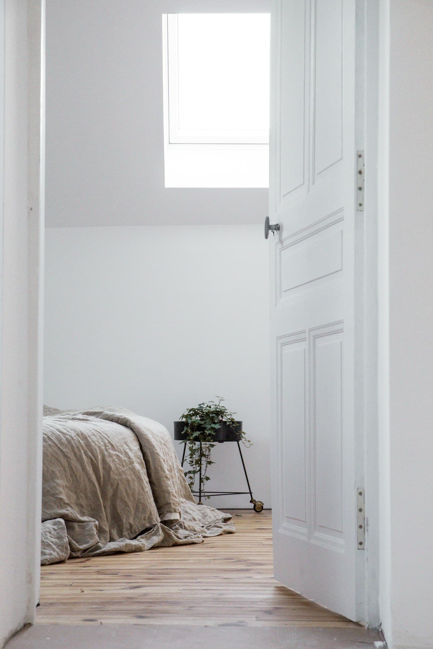 Soft linen bedding in a calm, light-filled bedroom